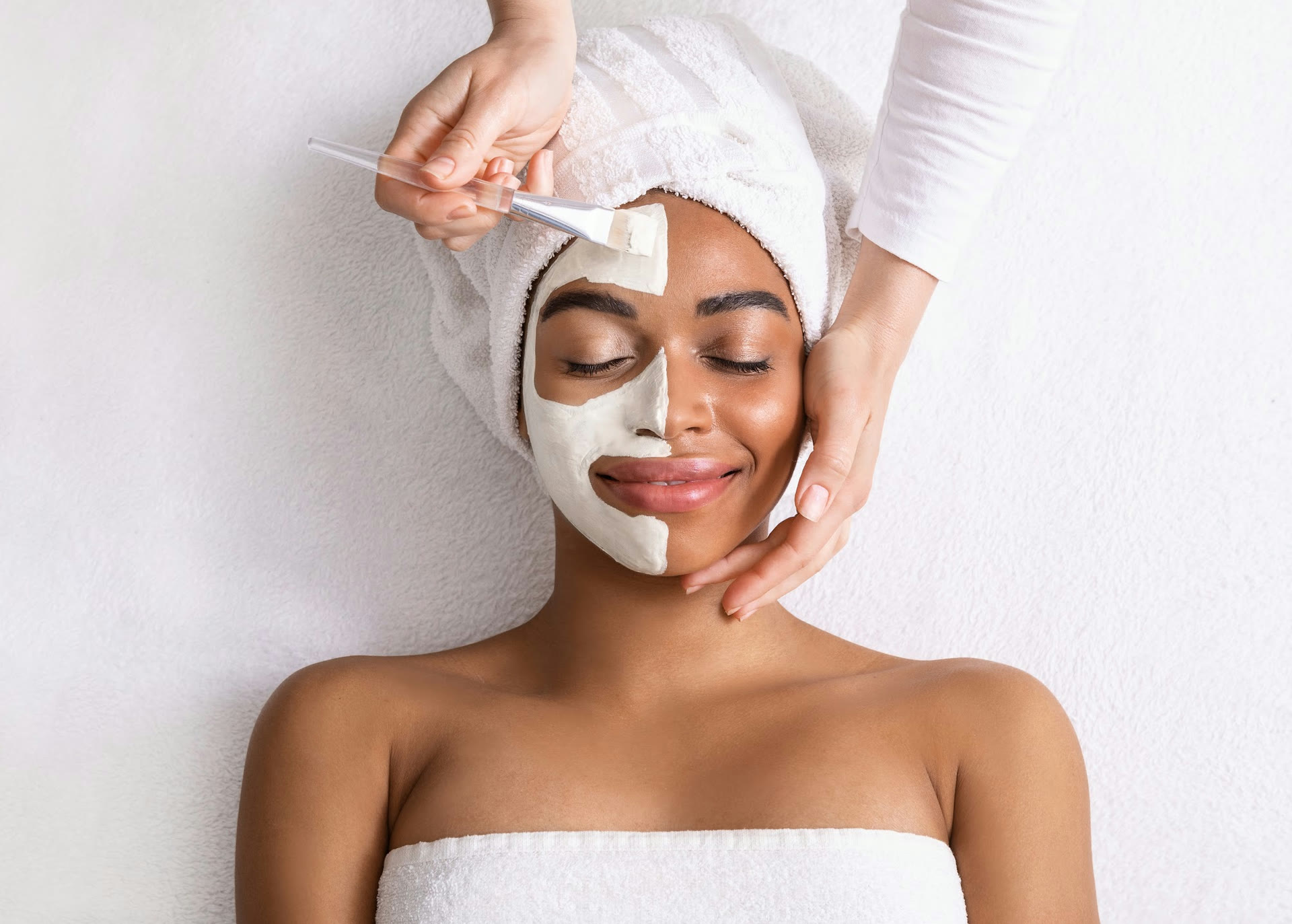 Clay facial mask application during a facial